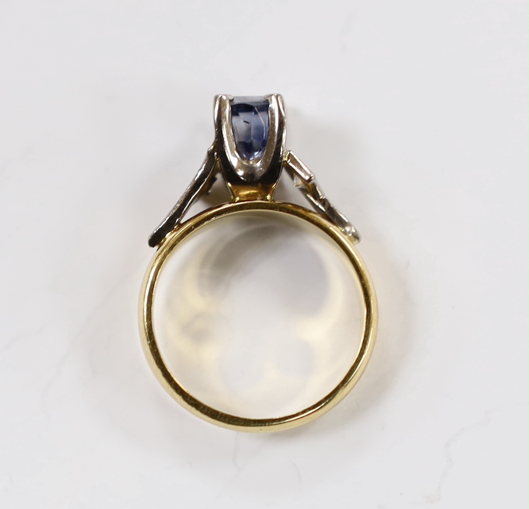 An 18ct and single stone oval cut sapphire set dress ring, with diamond set shoulders, size I, gross weight 5.6 grams.